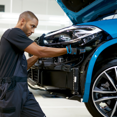 BMW Trained Technician exchanges the headlight on a BMW vehicle in a BMW Certified Collision Repair Center.